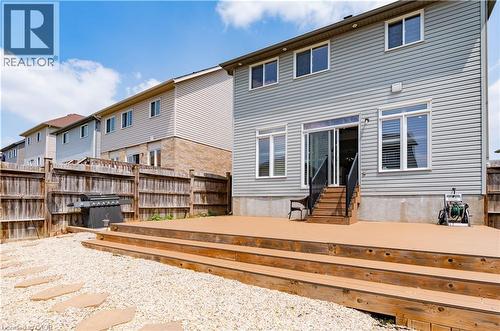 Expansive outdoor deck with multiple tiers, wood finish, and direct access to the interior via a sliding glass door - 122 Iron Gate Street, Kitchener, ON - Outdoor With Deck Patio Veranda With Exterior