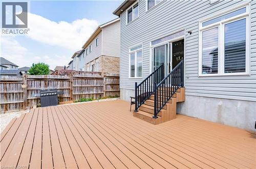 Expansive composite deck with dark railings, providing direct access to the interior through a sliding glass door - 122 Iron Gate Street, Kitchener, ON - Outdoor With Deck Patio Veranda With Exterior