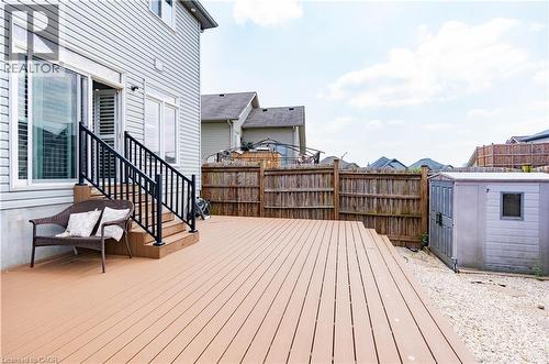 Spacious composite deck with integrated steps and black metal railings, featuring a sliding glass door entry - 122 Iron Gate Street, Kitchener, ON - Outdoor With Deck Patio Veranda With Exterior