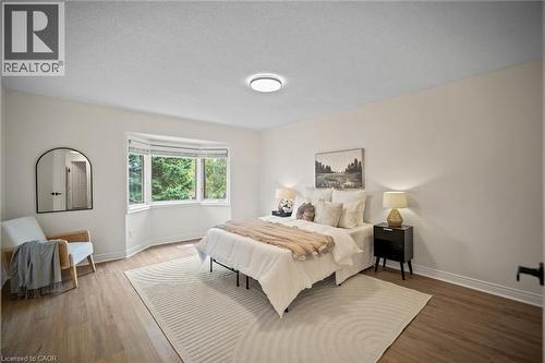 Light wood-finish flooring, white walls, and a bay window - 320 Hamilton Drive Unit# 10, Ancaster, ON - Indoor Photo Showing Bedroom