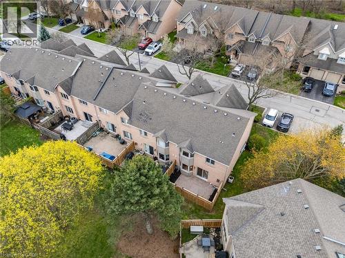Townhome exterior with a private fenced yard and a paved patio - 320 Hamilton Drive Unit# 10, Ancaster, ON - Outdoor With View