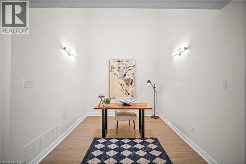Wood-finish flooring with white baseboards, complemented by bright white walls and recessed ceiling - 320 Hamilton Drive Unit# 10, Ancaster, ON - Indoor Photo Showing Other Room