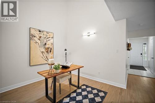 Vaulted ceiling with a flush-mount light fixture, wood-finish flooring, and white baseboards - 320 Hamilton Drive Unit# 10, Ancaster, ON - Indoor Photo Showing Other Room