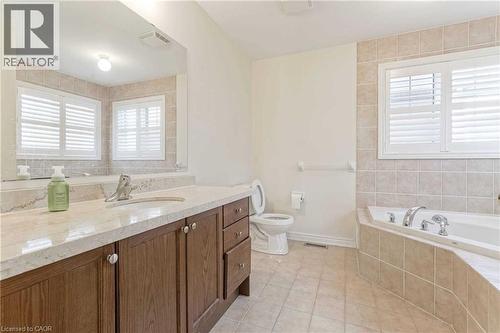Bathroom with a bath, vanity, and tile patterned floors - 3 Coolwater Drive Unit# Upper, Brampton, ON - Indoor Photo Showing Bathroom