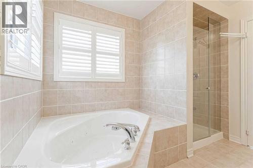 Full bathroom with a jetted tub, a stall shower, and tile patterned flooring - 3 Coolwater Drive Unit# Upper, Brampton, ON - Indoor Photo Showing Bathroom
