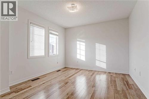 Unfurnished room featuring light wood-style floors and a textured ceiling - 3 Coolwater Drive Unit# Upper, Brampton, ON - Indoor Photo Showing Other Room