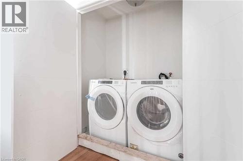 Laundry room with washer and clothes dryer and wood finished floors - 3 Coolwater Drive Unit# Upper, Brampton, ON - Indoor Photo Showing Laundry Room