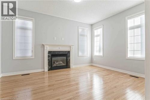 Unfurnished living room featuring light wood-style floors and a premium fireplace - 3 Coolwater Drive Unit# Upper, Brampton, ON - Indoor Photo Showing Living Room With Fireplace