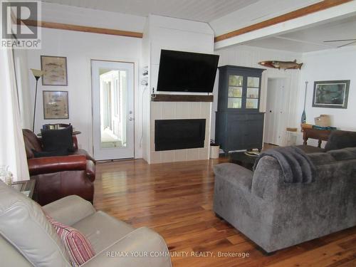 2 walkouts in Living Room / Propane Fireplace - 6576 Quarry Point Road, Ramara, ON - Indoor Photo Showing Living Room With Fireplace