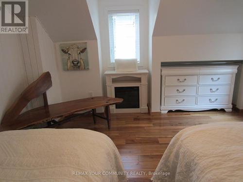 Electric fireplace and custom rough hewn bench - 6576 Quarry Point Road, Ramara, ON - Indoor Photo Showing Bedroom