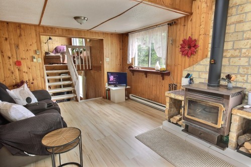 Salon - 1100 Ch. Des Collines, Rouyn-Noranda, QC - Indoor With Fireplace