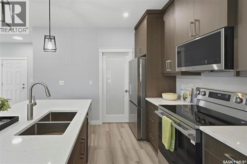 143 Sharma Lane, Saskatoon, SK - Indoor Photo Showing Kitchen With Stainless Steel Kitchen With Double Sink With Upgraded Kitchen