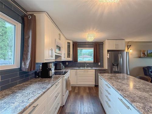 1106 Louise Avenue E, Brandon, MB - Indoor Photo Showing Kitchen With Double Sink