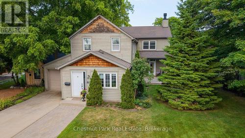 Surrounded by mature trees - 71 Hickory Street, Collingwood, ON - Outdoor With Facade