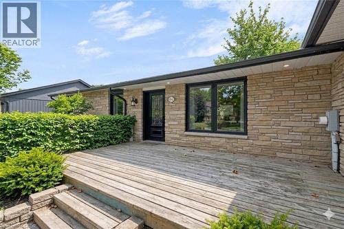Stone veneer exterior with a wood-finish deck - 44 Mcclellan Road, Alton, ON - Outdoor With Deck Patio Veranda