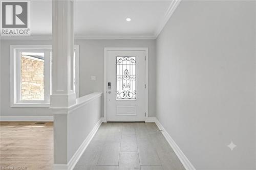 Entryway featuring tile flooring, a white door with decorative glass inlay, and a recessed ceiling light - 44 Mcclellan Road, Alton, ON - Indoor Photo Showing Other Room