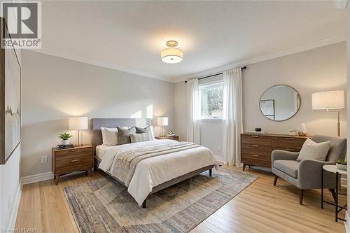 *VIRTUALLY STAGED* Light wood-finish flooring with crown molding - 44 Mcclellan Road, Alton, ON - Indoor Photo Showing Bedroom