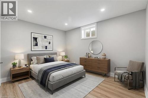 *VIRTUALLY STAGED* Recessed ceiling lighting, durable wood-finish flooring, and a window with white trim - 44 Mcclellan Road, Alton, ON - Indoor Photo Showing Bedroom