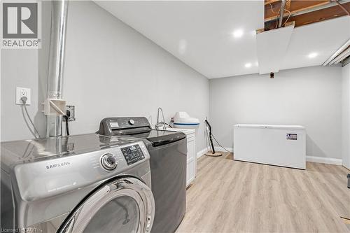 Recessed lighting illuminates wood-finish flooring - 44 Mcclellan Road, Alton, ON - Indoor Photo Showing Laundry Room