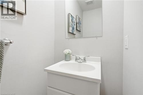 White vanity with an integrated sink and chrome faucet - 509 Quiet Place Unit# 1, Waterloo, ON - Indoor Photo Showing Bathroom
