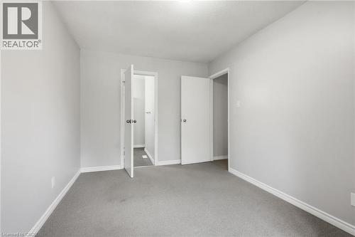 Carpeted interior room with light grey walls and white baseboards - 509 Quiet Place Unit# 1, Waterloo, ON - Indoor Photo Showing Other Room