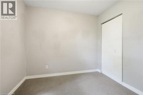 Neutral-toned walls complement the light gray carpet flooring - 509 Quiet Place Unit# 1, Waterloo, ON - Indoor Photo Showing Other Room