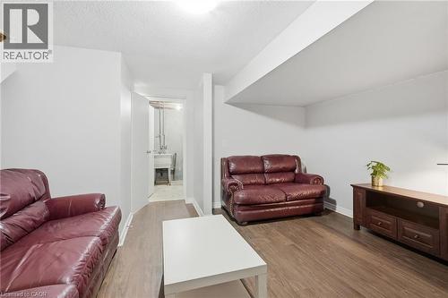 Open concept room with wood-finish flooring, light neutral wall paint, and a white ceiling - 509 Quiet Place Unit# 1, Waterloo, ON - Indoor