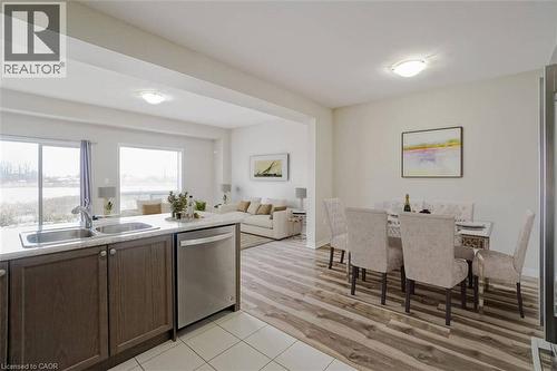 Open-concept living space with wood-finish flooring, white walls, and recessed lighting - 70 Bradbury Road, Hamilton, ON - Indoor Photo Showing Kitchen With Double Sink