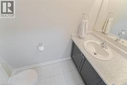 Vanity with gray cabinetry, an integrated sink, and speckled countertop - 