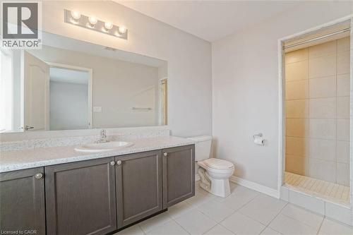 Spacious bathroom featuring a large vanity with ample counter space, built-in cabinetry, an integrated sink, and a tiled shower stall - 70 Bradbury Road, Hamilton, ON - Indoor Photo Showing Bathroom