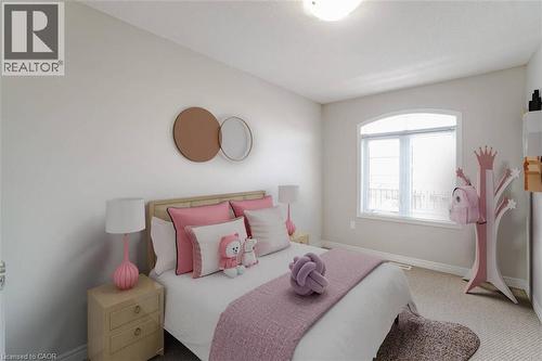Arched transom window with white framing, plush carpet flooring, and neutral wall paint - 70 Bradbury Road, Hamilton, ON - Indoor Photo Showing Bedroom