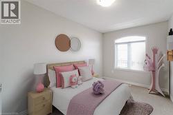 Arched transom window with white framing, plush carpet flooring, and neutral wall paint - 