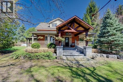 Brick exterior with gabled roofline and covered front porch - 875 Safari Road, Hamilton, ON 