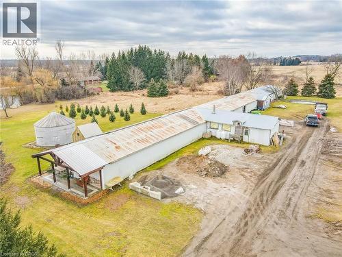 Long agricultural building with a metal roof and a covered outdoor patio - 875 Safari Road, Hamilton, ON 