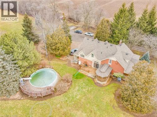 Brick exterior with dormer windows and a multi-level shingle roof - 875 Safari Road, Hamilton, ON 