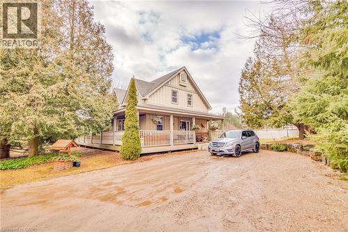Board and batten exterior with an expansive wrap-around porch - 875 Safari Road, Hamilton, ON 