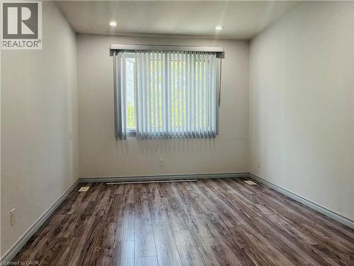 Wall-to-wall wood-finish flooring - 83 Keewatin Avenue, Kitchener, ON - Indoor Photo Showing Other Room