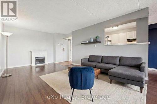 404 - 65 Silvercreek Parkway N, Guelph (Junction/Onward Willow), ON - Indoor Photo Showing Living Room With Fireplace