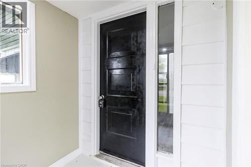 Panelized black entry door with a white frame and sidelight - 15 Spiers Crescent, Cambridge, ON -  With Exterior