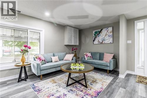Recessed lighting, light gray wall paint, wood-finish flooring, white window trim, and white baseboards - 15 Spiers Crescent, Cambridge, ON - Indoor Photo Showing Living Room