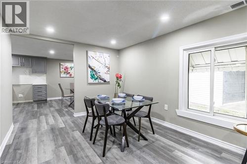 Recessed ceiling lighting, wood-finish flooring, sliding window, gray shaker cabinetry, and a white tile backsplash - 15 Spiers Crescent, Cambridge, ON - Indoor