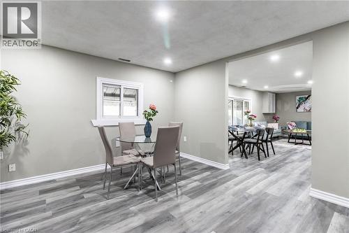 Recessed lighting, wood-finish flooring, white trim, and a window with a white frame - 15 Spiers Crescent, Cambridge, ON - Indoor Photo Showing Dining Room
