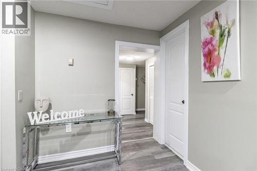 Wood-finish flooring throughout, white interior doors, and crisp white trimwork - 15 Spiers Crescent, Cambridge, ON - Indoor