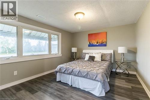 Large window with white trim, wood-finish flooring, and recessed ceiling lighting - 15 Spiers Crescent, Cambridge, ON - Indoor Photo Showing Bedroom