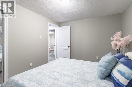 Smooth painted walls with a textured ceiling - 15 Spiers Crescent, Cambridge, ON - Indoor Photo Showing Bedroom