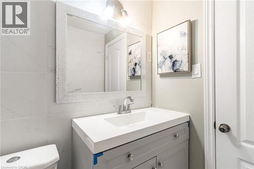 Vanity with a built-in sink, chrome faucet, and integrated lighting - 15 Spiers Crescent, Cambridge, ON - Indoor Photo Showing Bathroom