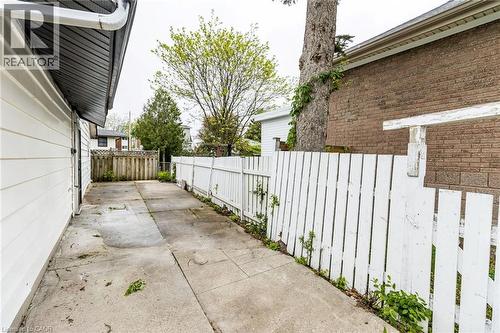 Paved side yard with a white picket fence and wood privacy fence - 15 Spiers Crescent, Cambridge, ON - Outdoor With Exterior