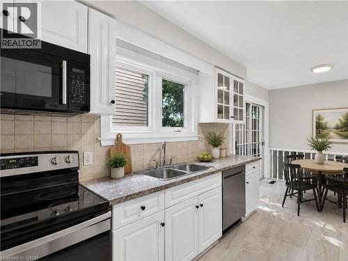Virtually Staged. - 3401 Rockwood Drive, Burlington, ON - Indoor Photo Showing Kitchen With Double Sink
