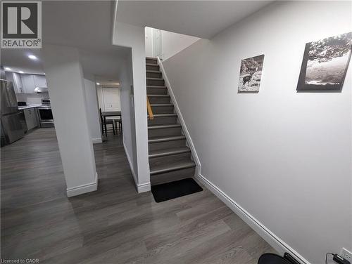 Wood-finish flooring throughout, with a neutral wall color and recessed lighting - 510 Oakridge Place, Waterloo, ON - Indoor Photo Showing Other Room