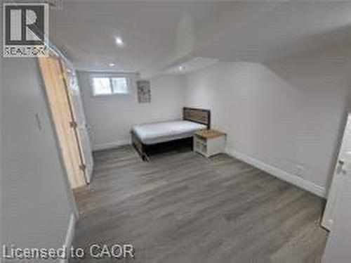 Wood-finish flooring, recessed lighting, and a window for natural light - 510 Oakridge Place, Waterloo, ON - Indoor